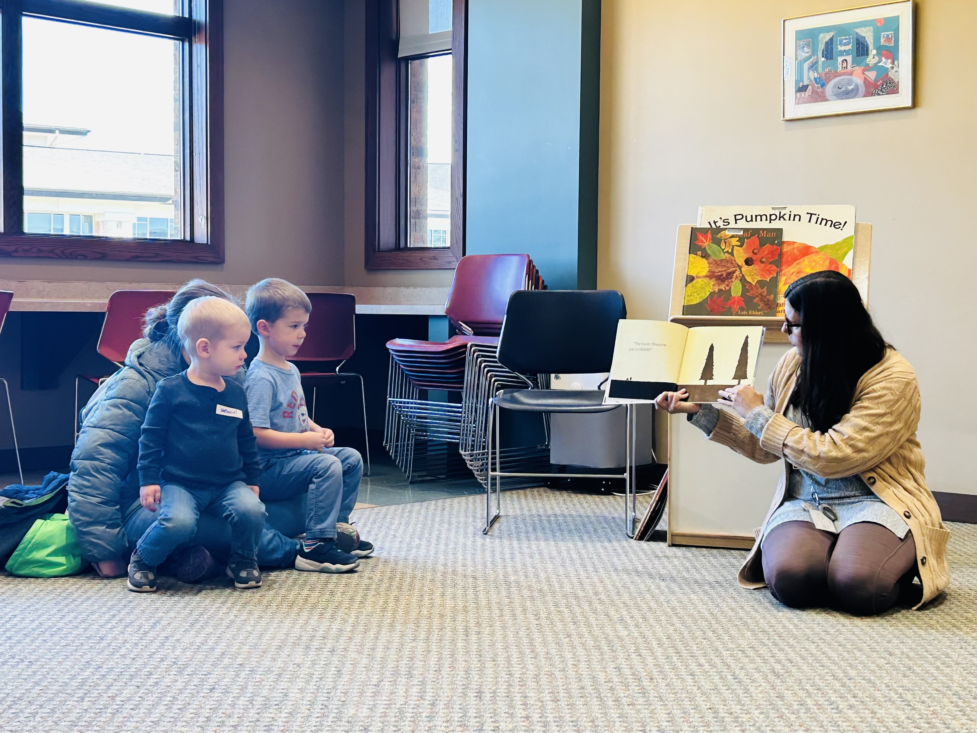 Librarian reading a story to a family during storytime
