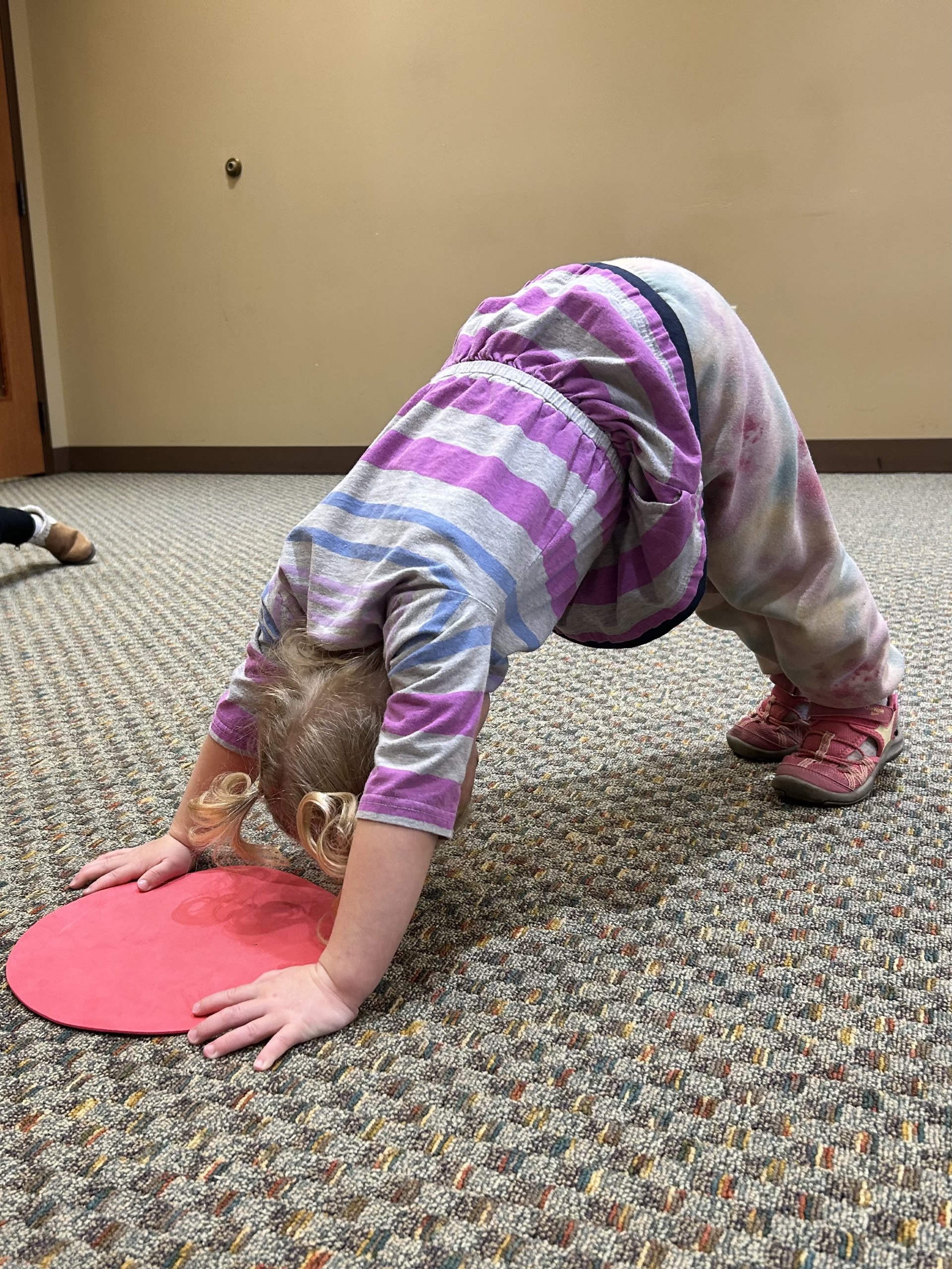 Child doing downward dog yoga pose