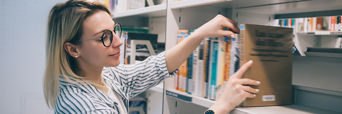 Woman taking a book from the shelf