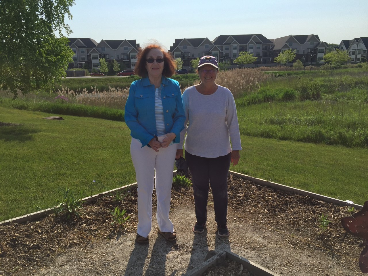 Two women volunteering in the library garden