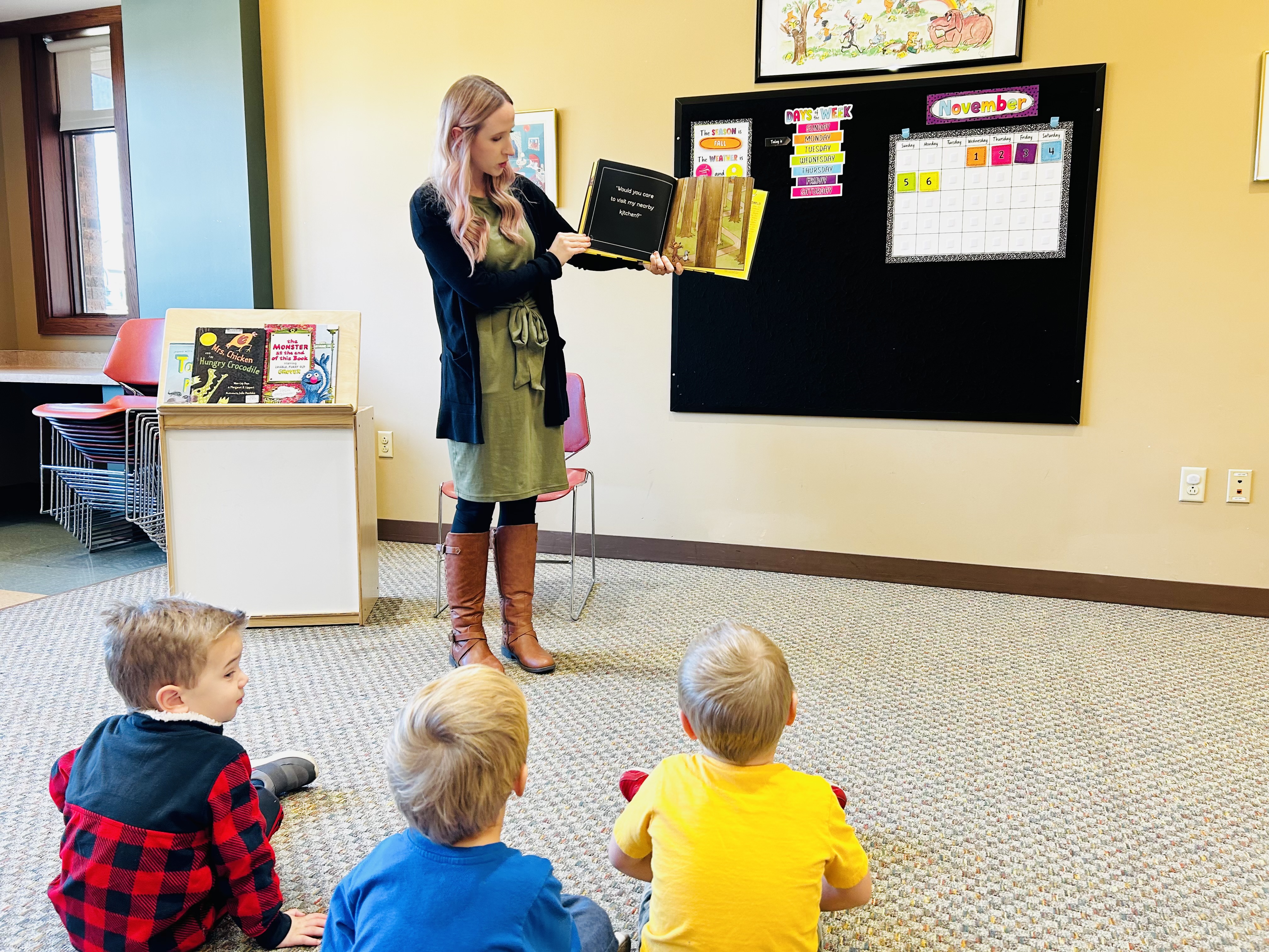 Librarian reading a story to a group of children 