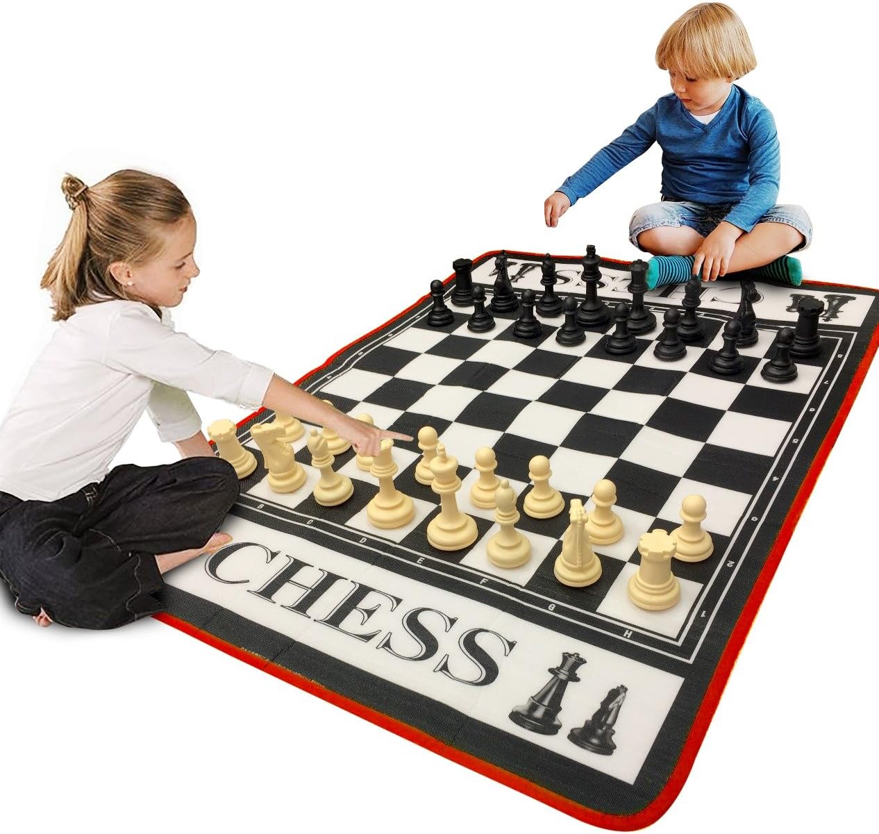image of boy and girl playing chess on large mat
