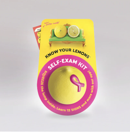 image of a yellow lemon with a pink breast cancer ribbon; the accompanying package says "Know Your Lemons", "Self-exam kit"