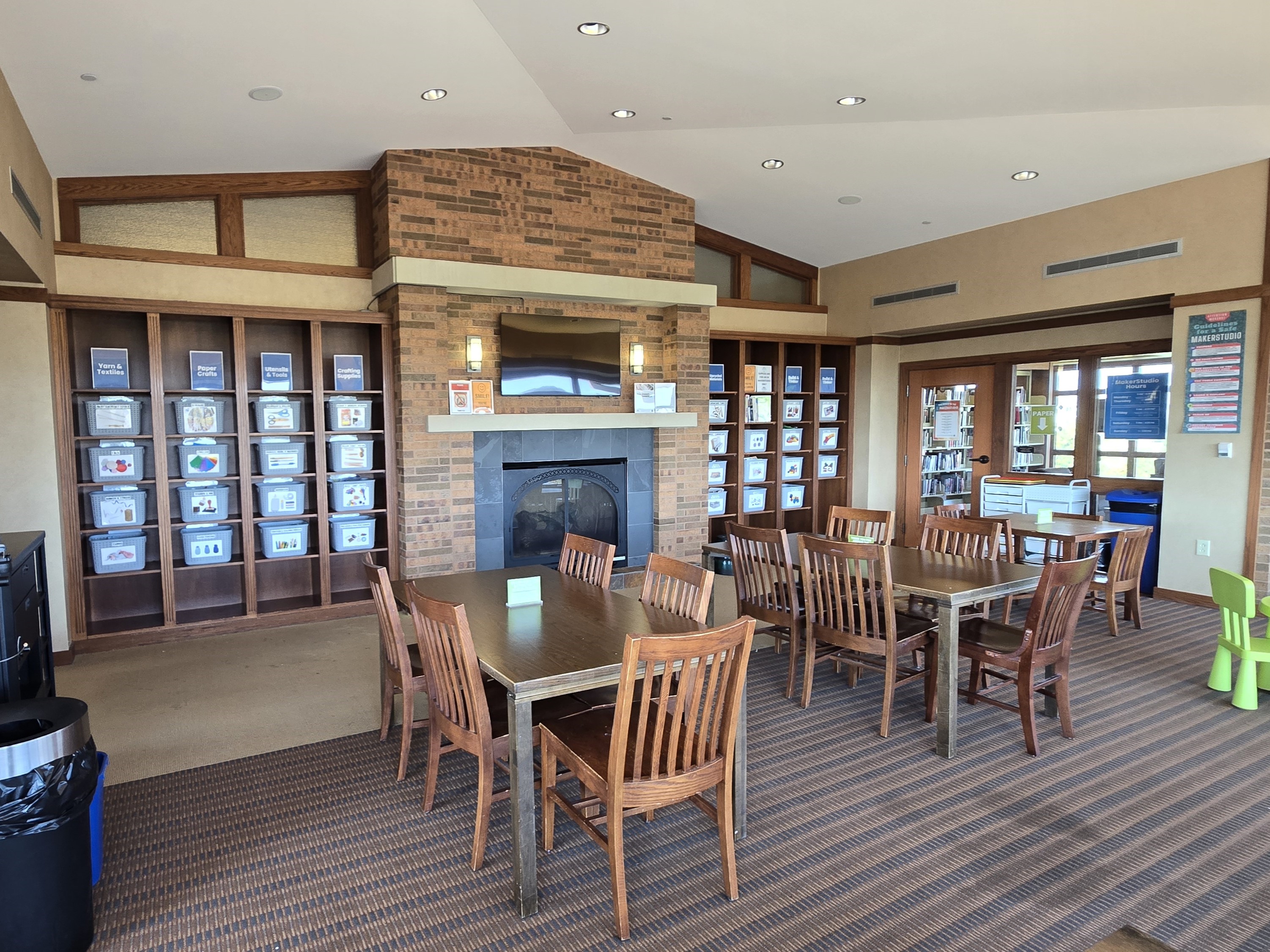 image of MakerStudio space with shelves of craft supplies, tables and chairs