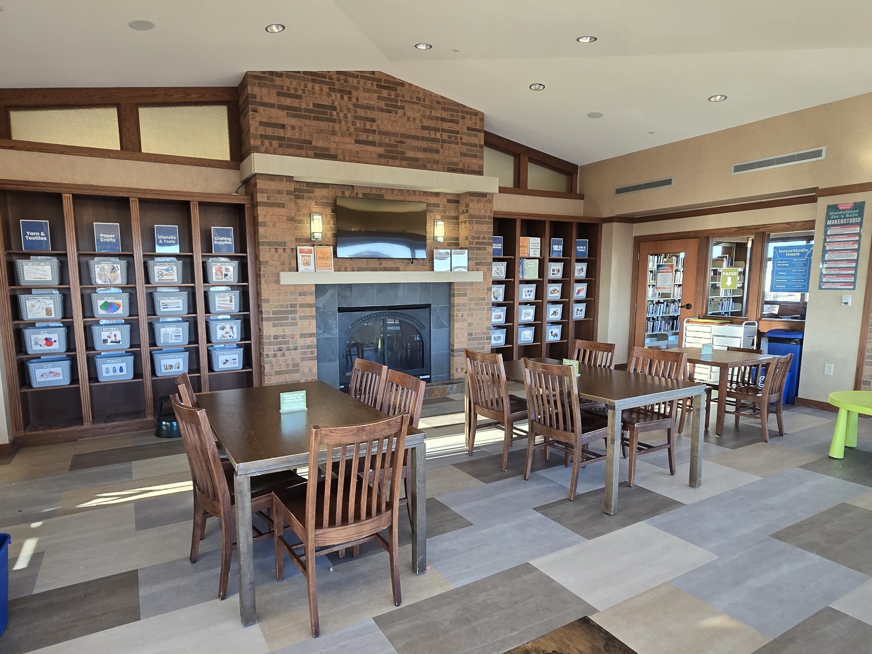 image of MakerStudio space with shelves of craft supplies, tables and chairs