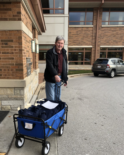 Man with wagon full of materials for home delivery