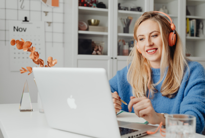 Woman with headphones using a laptop