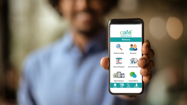 Man holding phone with screen open to CAFE Libraries App