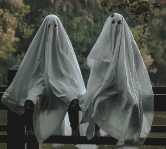 Photo of two people dressed like ghosts