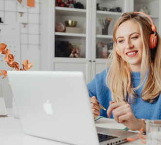 Woman with headphones using a laptop