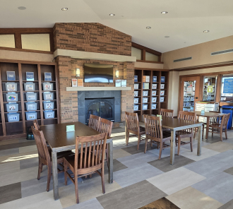 image of MakerStudio space with shelves of craft supplies, tables and chairs