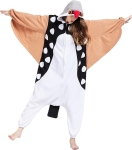Woman in bird onesie costume. The body is mainly white and black; there are white polka dots on the black part of the costume. Her arms are outstretched to look like wings and the hood has eyes and a red beak.