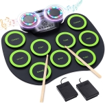 black and green roll-up electronic drum with 9 pads and 2 speakers. There are 2 drum sticks and 2 foot pedals also in the picture