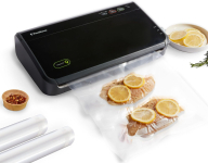 image of a food vacuum sealer; some type of meat with orange slices is being sealed