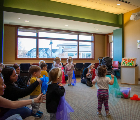 children and parents playing with scarves