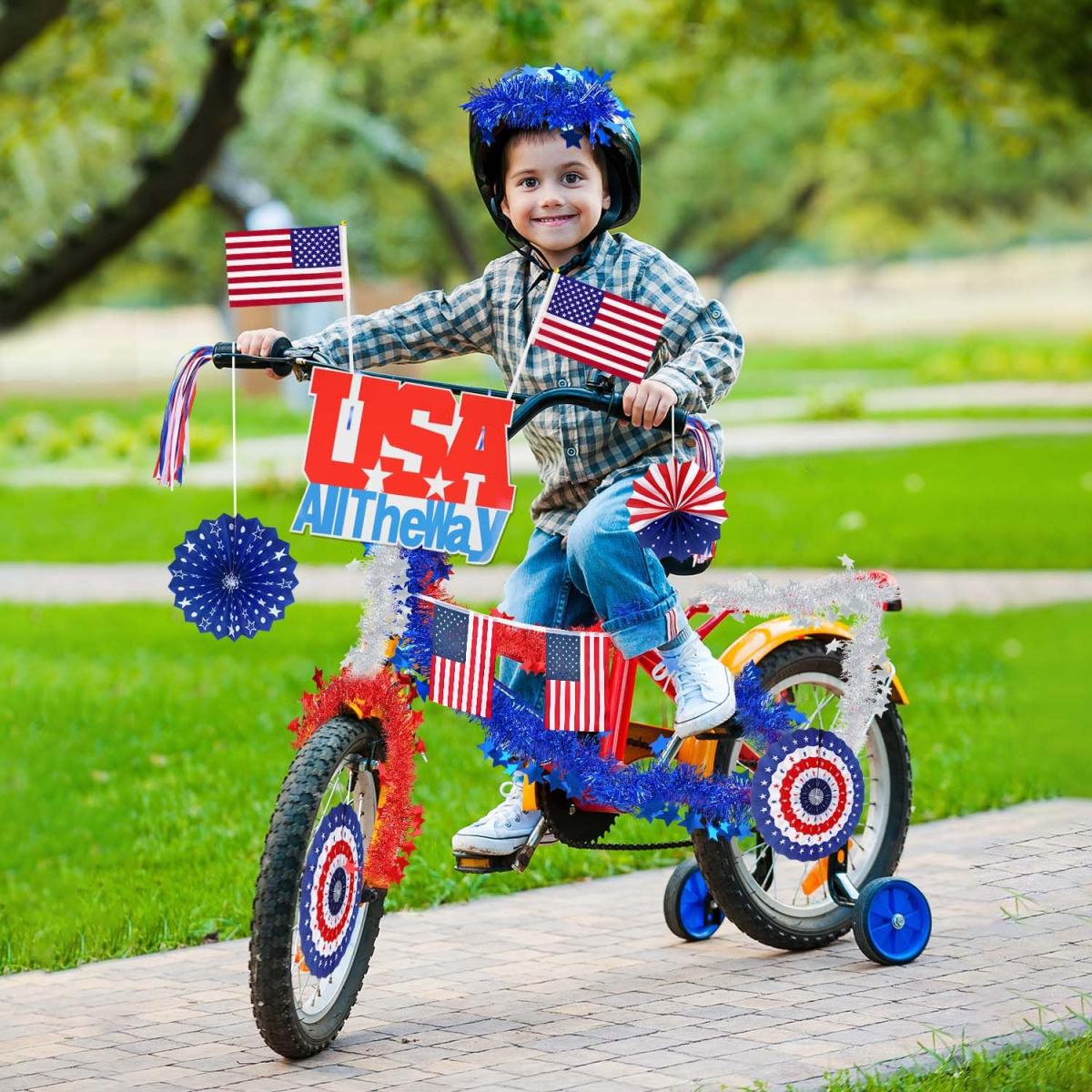 young boy on bike decorate with red white and blue streamers and flags