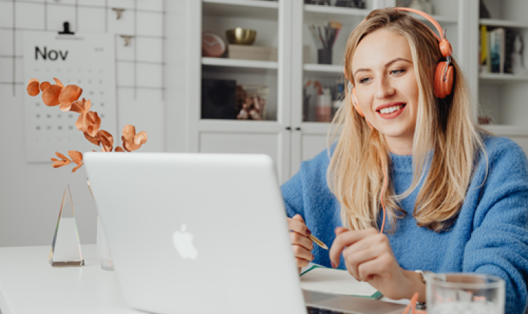Woman with headphones using a laptop