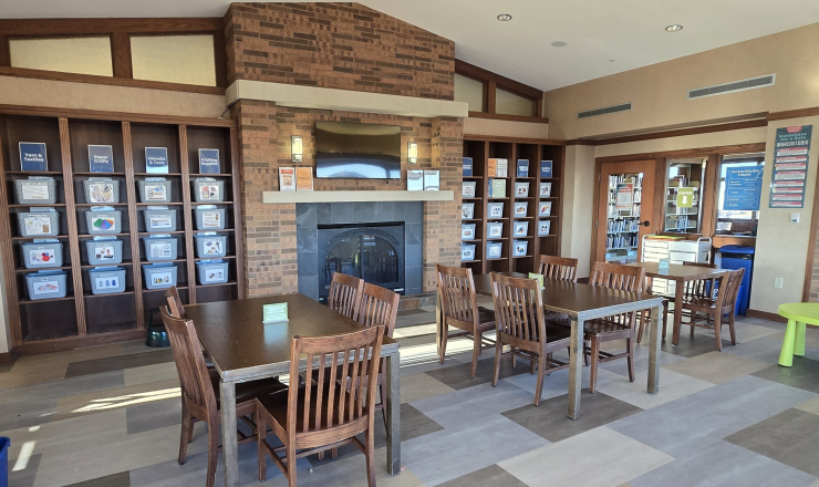 image of MakerStudio space with shelves of craft supplies, tables and chairs